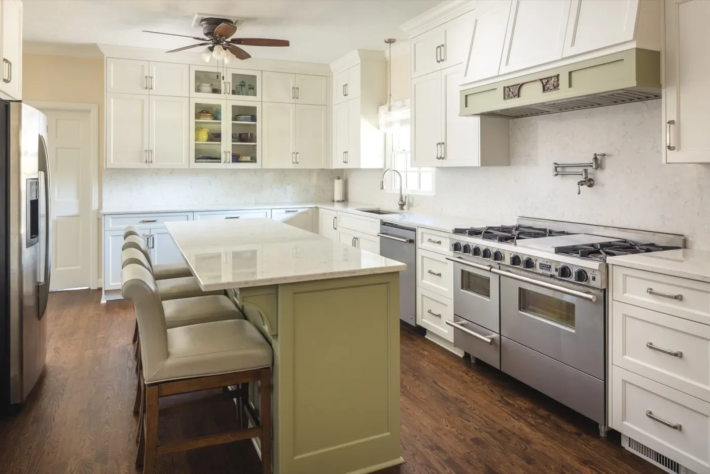 Kitchen remodel with light gray cabinets and brass hardware