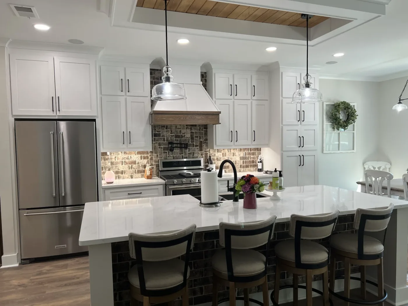 Kitchen remodel with white cabinets, subway tile backsplash, and black granite countertops