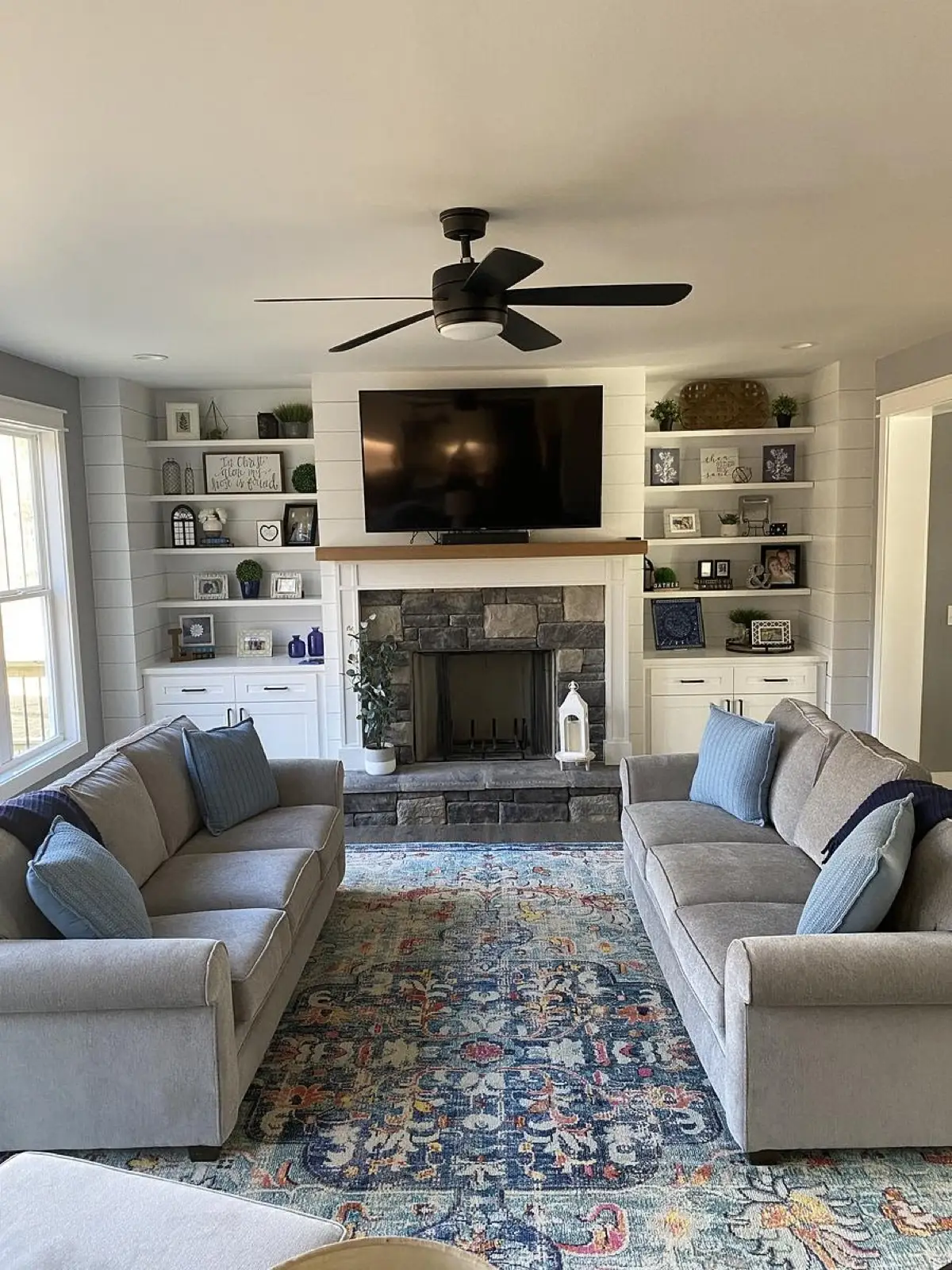 Custom home kitchen with white shaker cabinets, wood coffered ceiling, and black granite island